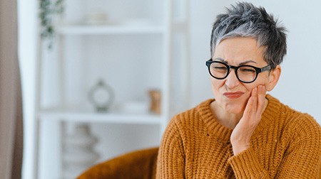 A senior woman with a toothache