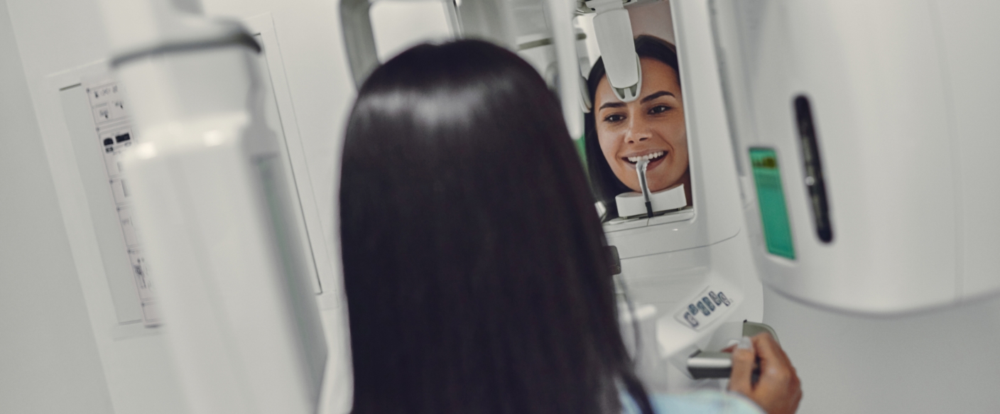 Woman getting cone beam 3 D imaging of her mouth in Tampa dental office