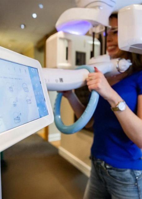 Dental patient having her mouth scanned by cone beam 3 D imaging technology