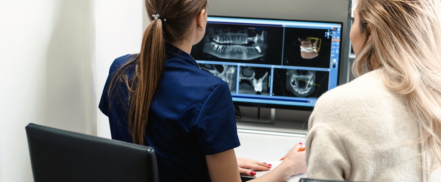 Dentist looking at a computer with digital dental x rays in Tampa