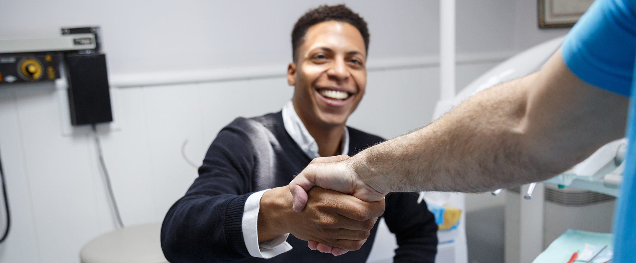 Smiling man shaking hands with his implant dentist in Tampa