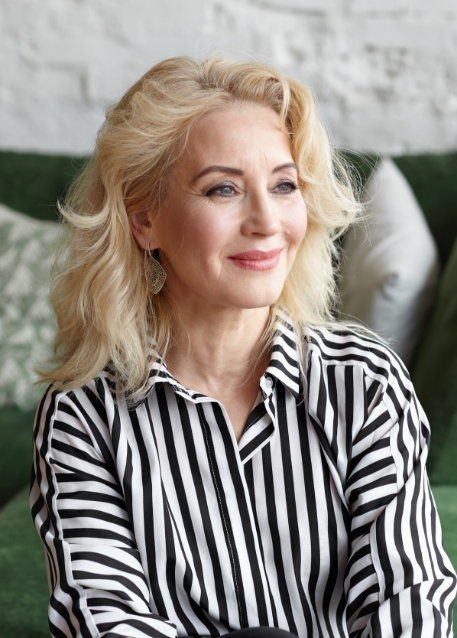 Smiling woman in black and white striped blouse