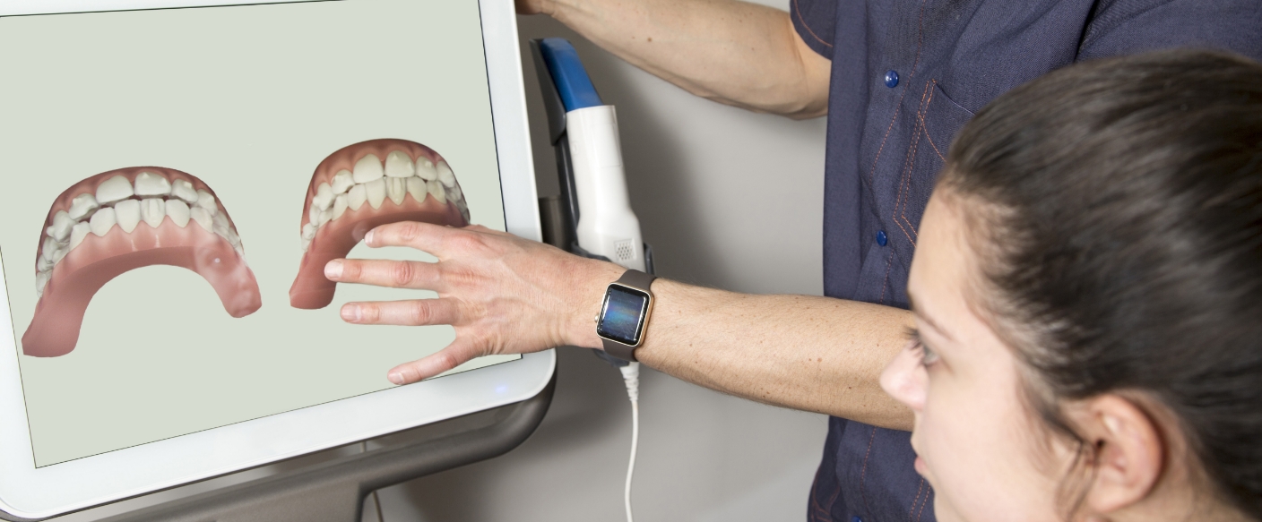 Dentist showing a patient digital scans of their teeth