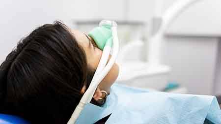 Patient in treatment chair wearing nasal mask