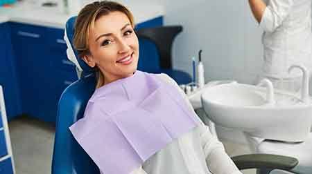 Woman smiling while sitting in treatment chair