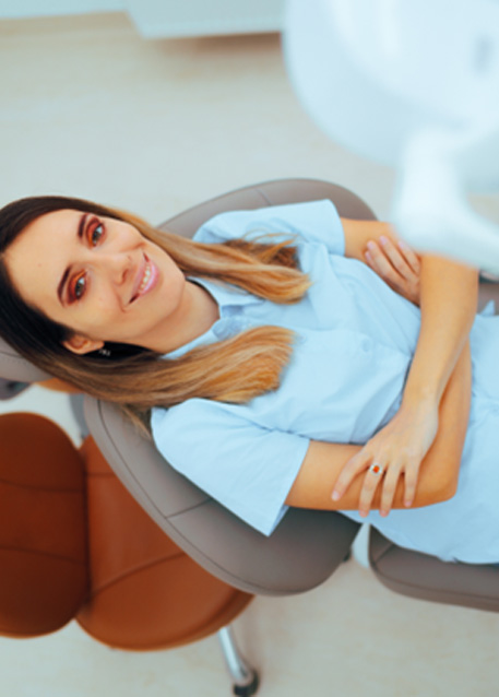 Woman leaning back in treatment chair and smiling