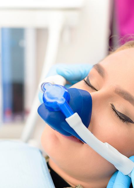 Woman with mask over nose for sedation dentistry in Tampa